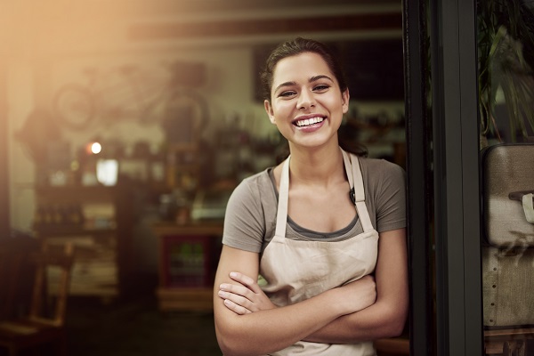 Woman in apron outside cafe